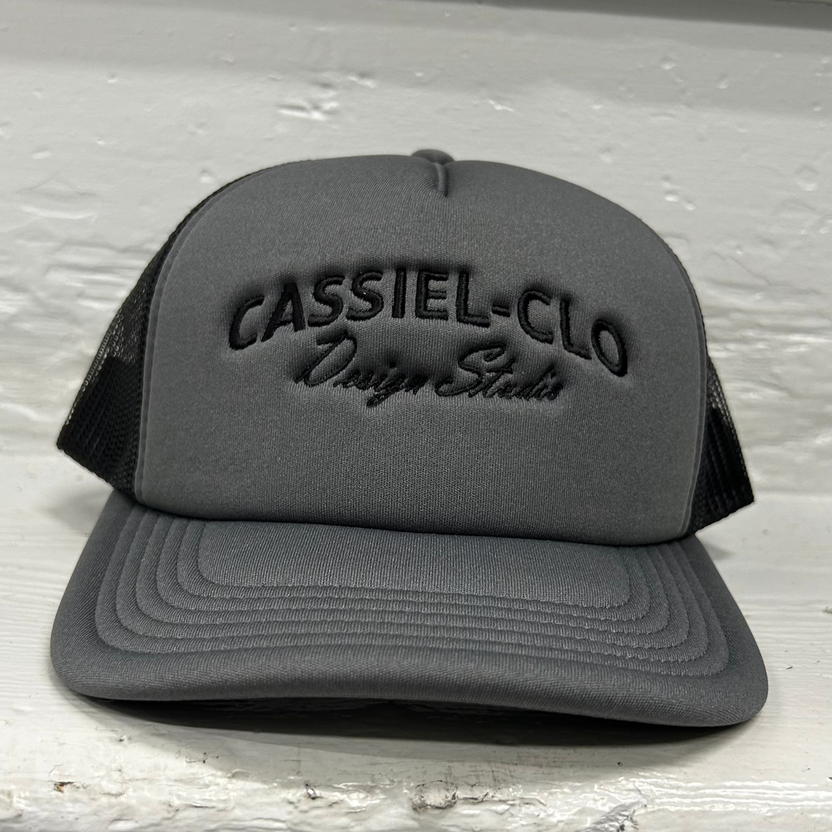 Cassiel Clo Arch Logo Grey Foam Trucker Cap